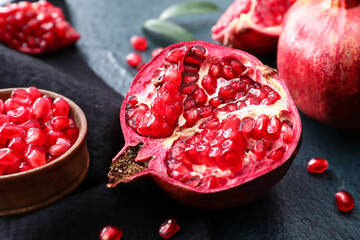 Ripe delicious pomegranates on dark background