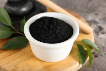 Bowl with activated charcoal tooth powder on table