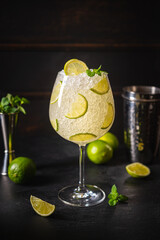 Margarita cocktail with lime and ice on dark wooden table with copy space. Classic Margarita and Daiquiri Cocktail.