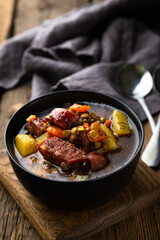 Winter hot thick soup with lentils and smoked sausage