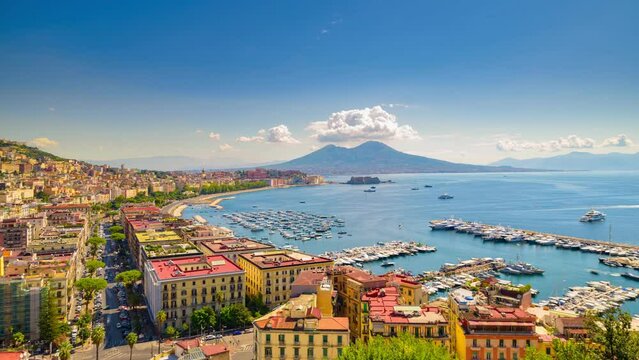 Naples, Italy. View of the Gulf of Naples from the Posillipo hill with Mount Vesuvius far in the background Boats come in and out to the marina. Time lapse video with panning effect.