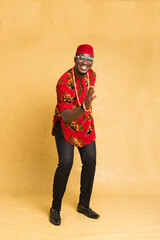 Igbo Traditionally Dressed Business Man Standing Dancing with Hand forward