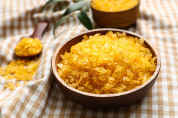 Bowl of orange sea salt on napkin, closeup