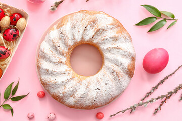 Plate with tasty Easter cake and eggs on pink background