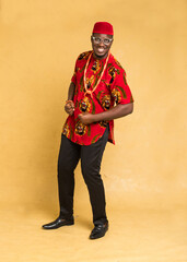 Igbo Traditionally Dressed Business Man Standing and Posturing Happily