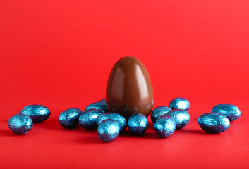 Chocolate Easter eggs on red background