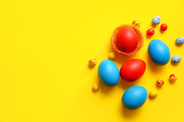 Red and blue Easter eggs on color background