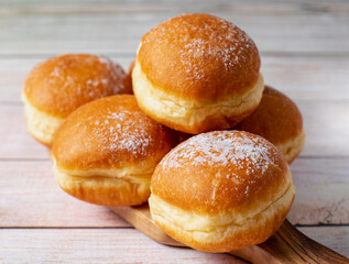 European Sweetness Defined: Cream-Filled Krapfen and Berliner, Austria and Germany's Pride on white table. Selective focus