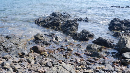 The splashing waves on the black rocks 