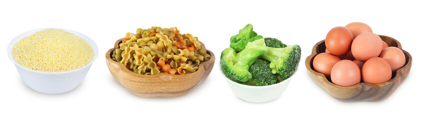 Colored pasta, chicken eggs, frozen broccoli and couscous  in a bowl isolated on a white background.  Set of full white bowl