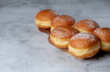 Donut Delights: Savoring Austrian Krapfen and German Berliner's Creamy Centered Wonders. On white table. Selective focus