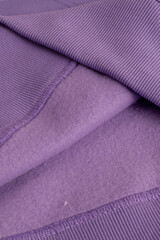 Hoodie texture. Close-up shot of sweatshirt hoodie brown textile warm fabric macro background. Violet color