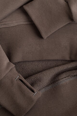 Hoodie texture. Close-up shot of sweatshirt hoodie brown textile warm fabric macro background.