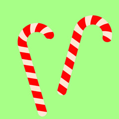 Сhristmas candies bent,red and light beige stripes,on a green backgraund.