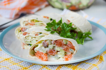 Salmon, avocado and cream cheese roll in lavash