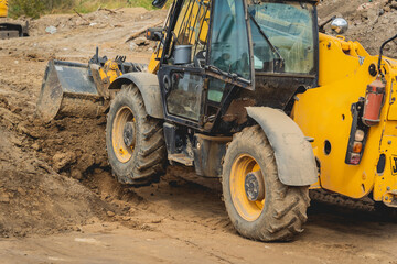 Wheel loader excavator works at construction site