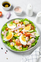 Shrimp egg salad salad on plate on light background. Copy space.
