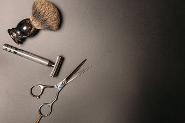 tools for shaving and haircuts on a black background, copy space
