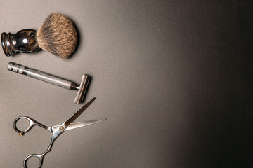 tools for shaving and haircuts on a black background, copy space