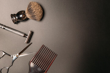 barber tools for shaving and haircuts on a black background, copy space