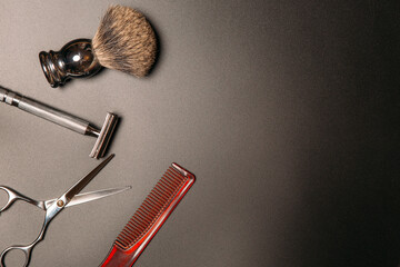 barber tools for shaving and haircuts on a black background, copy space