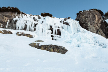 Frozen waterfall Skok in High Tatras (Slovakia) in winter time. Big waterfall with blue giant icicles frost on the rocks. © Matt Benzero