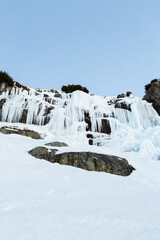 Frozen waterfall Skok in High Tatras (Slovakia) in winter time. Big waterfall with blue giant icicles frost on the rocks. © Matt Benzero