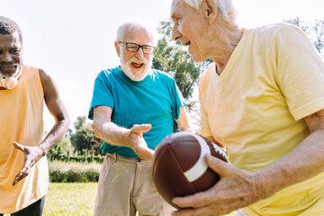 Group of senior friends playing at the park. Old multiethnic friends making activities outdoor....