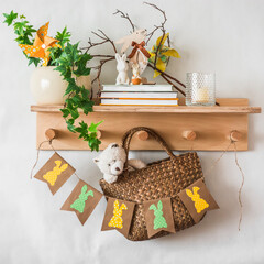 Easter decoration. Children's room interior - wooden shelf on the wall with handmade easter decorations, children's toys and books. Cozy interior concept