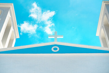Church cross on top of roof on blue sky background