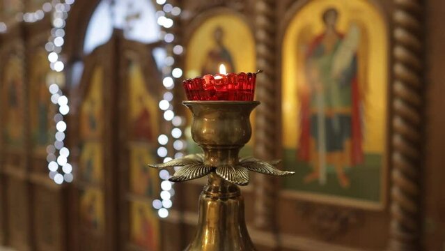 a lamp in front of an icon in an Orthodox church