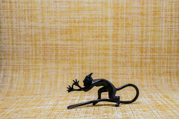 Cast statuette of a little devil on a motley background