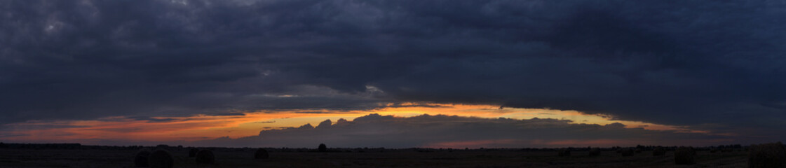 Landscape panorama with dark sky at sunset