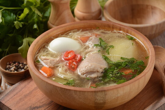 South American Caldo de Gallina chicken noodle soup with boiled egg and herbs. The classic Peruvian chicken noodle soup.