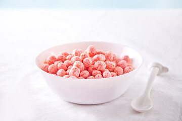 Fototapeta na wymiar bowl with strawberry sweet corn balls. Delicious and healthy breakfast cereal.