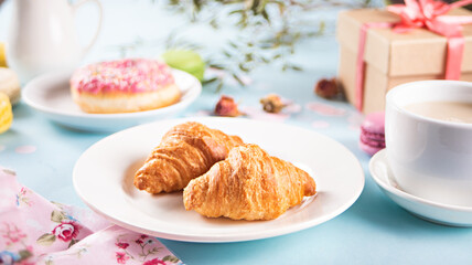 Fresh baked croissants and cup of tea. Healthy lifestyle concept.