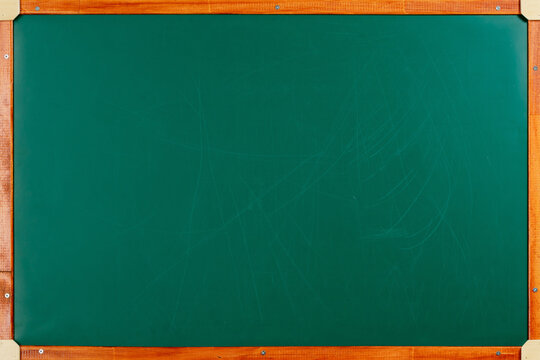 Empty green chalkboard with orange wooden frame