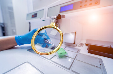 Laboratory assistant works at paraffin wax dispenser tissue embedding machine.