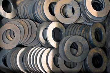 Steel discs cut on an industrial laser machine are folded into a box for transportation, top view. Metalworking at the factory. Close-up. 