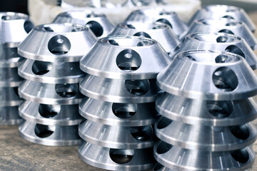 Turned metal parts stacked on a pallet. Metalworking on industrial equipment.