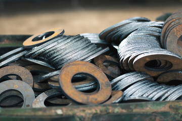 Round metal products from sheet steel cut on CNC plasma cutting machine, metalworking close-up at the factory