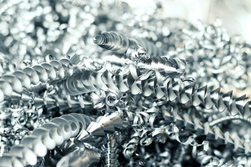 Steel shavings close-up, waste after processing a steel part on a lathe. Photo with selective...