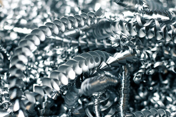 Steel shavings close-up, waste after processing a steel part on a lathe. Photo with selective focus 