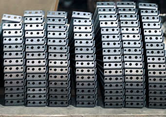 Steel products bent on a bending machine stacked in stacks, close-up. Sheet metal processing in a factory. 
