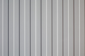 White wall with metal sheeting and lines