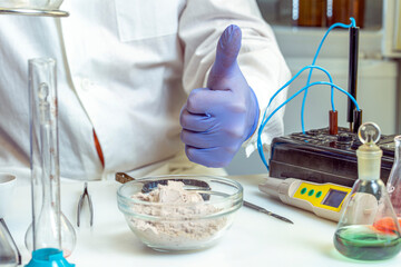 Analysis of sports nutrition in the laboratory. The inspector is satisfied with the results of the whey protein powder analysis.