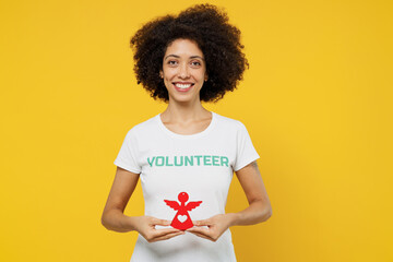 Young woman of African American ethnicity wears white volunteer t-shirt hold in hands little paper...