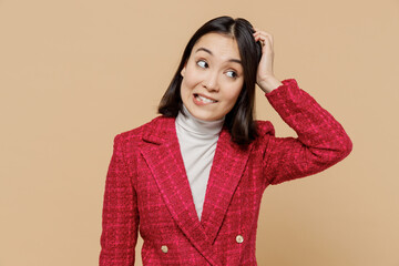 Puzzled thoughtful confused mistaken woman of Asian ethnicity wear red jacket look aside scratch...