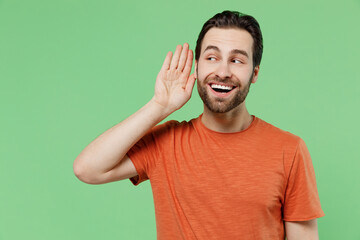 Young curious nosy man 20s wearing casual orange t-shirt try to hear you overhear listening...