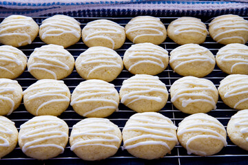 Rows of fresh homemade lemon sugar cookies with drizzled icing; Pretty white cookies with zig zag...